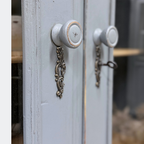 Period-style escutcheons and round wooden knobs on hand-finished reclaimed pine glazed cupboard doors, authentic vintage hardware