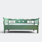Hand-carved spindle sides and scalloped back rail detail on solid pine Dutch monks bench, traditional heart cut-outs, hand-distressed paint finish