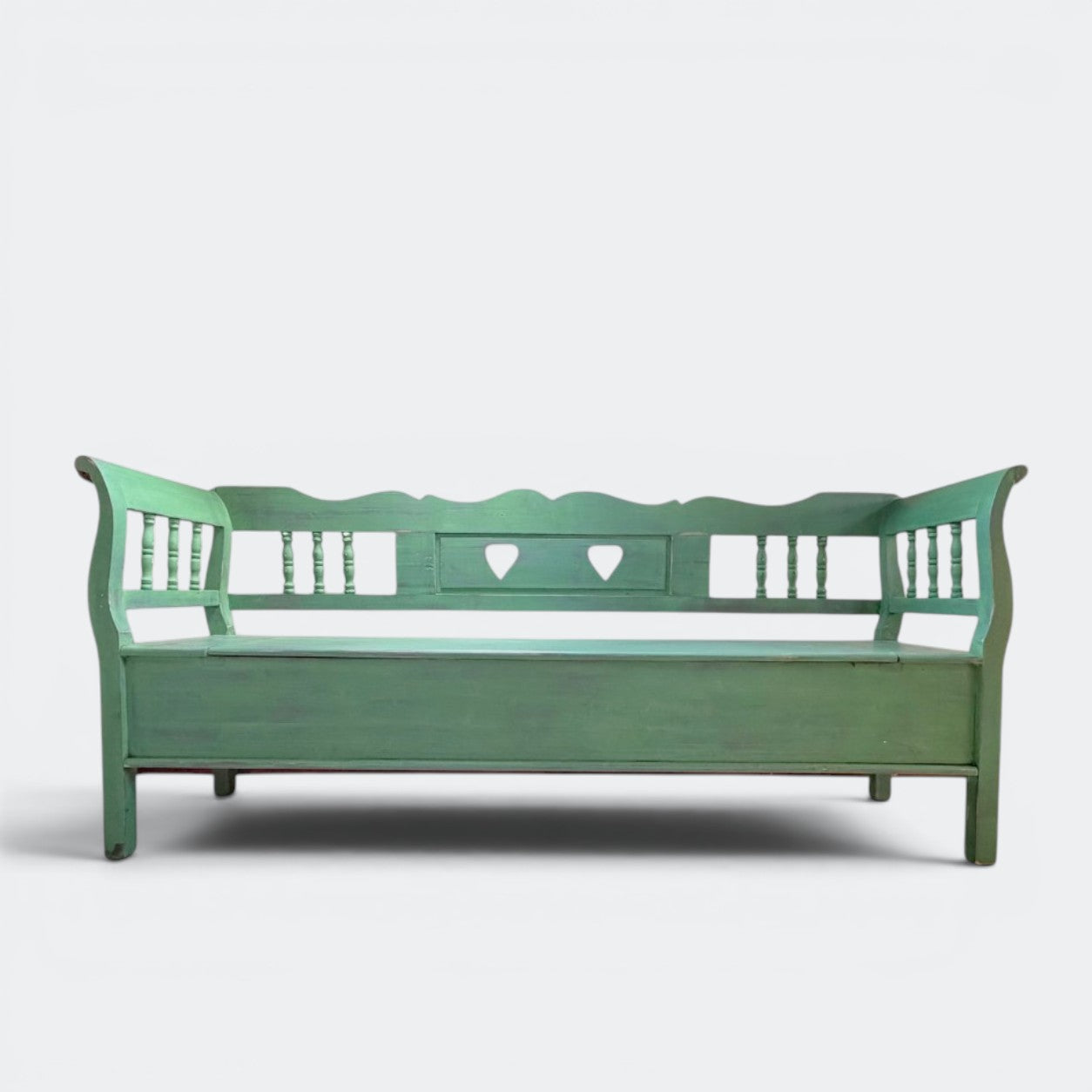 Hand-carved spindle sides and scalloped back rail detail on solid pine Dutch monks bench, traditional heart cut-outs, hand-distressed paint finish