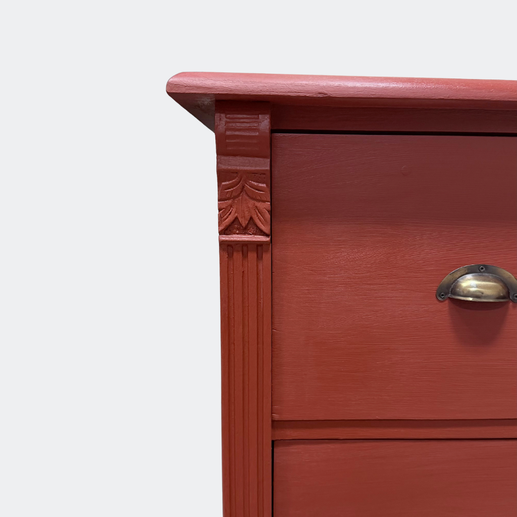 Close-up of vintage-style metal cup pulls on a handcrafted "Rusty Nail" red solid-wood drawer unit.