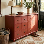 Large red farmhouse storage unit in a luxury country entryway, showcasing its architectural proportions and heirloom quality.