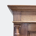 Hand-turned oak column framing and panelled door detail on vintage solid oak wardrobe, traditional European craftsmanship, authentic historic patina