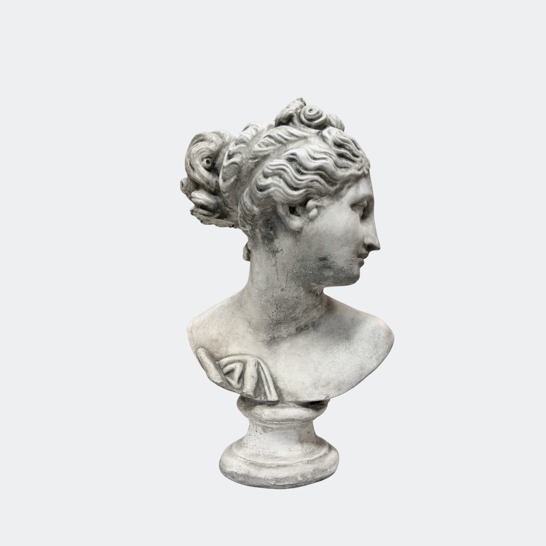 Stone female classical bust styled on painted sideboard between stone jar lamps at This Country Home showroom